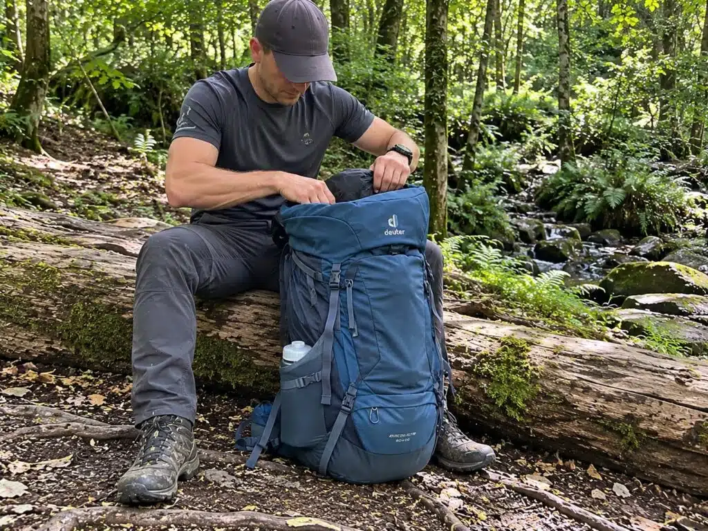 Me sitting on a fallen tree taking somethng out of the backpack