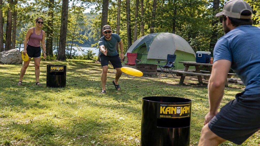 3 adults playing Kan Jam Disc Toss Game