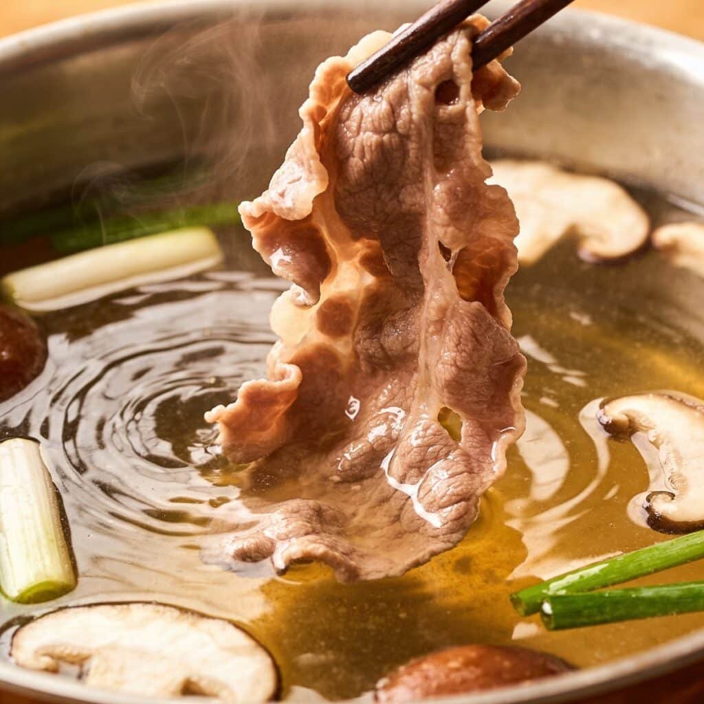 Adding meat to Campfire Pho Ramen