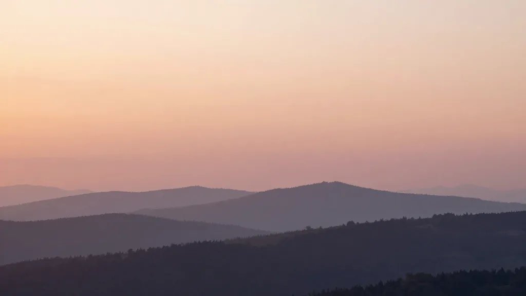 distant dawn over Craggy Gardens overlook, hazy ridge lines, pink-gold sky