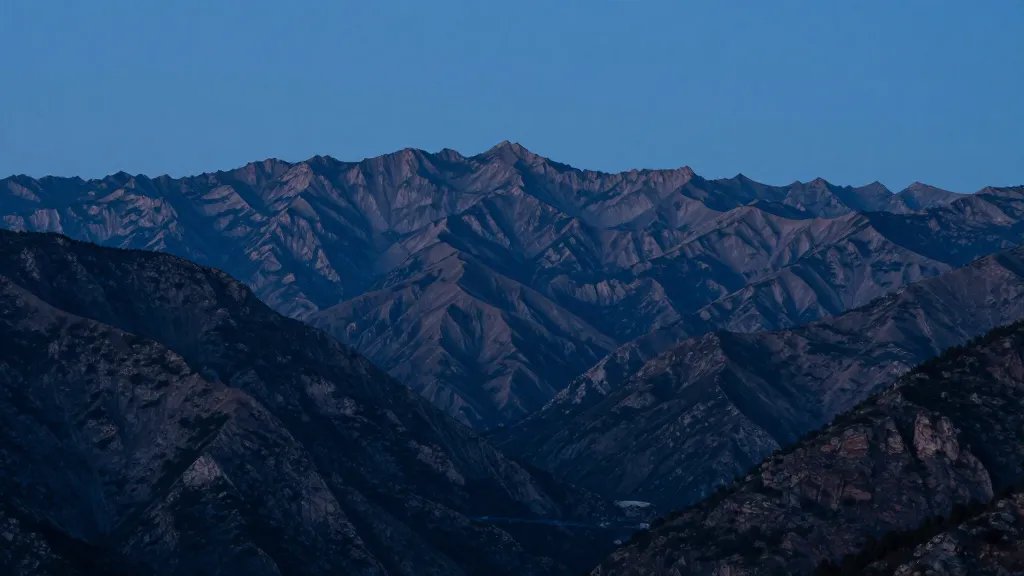 Distant view of The Crested Basin Loop's jagged peaks at blue hour