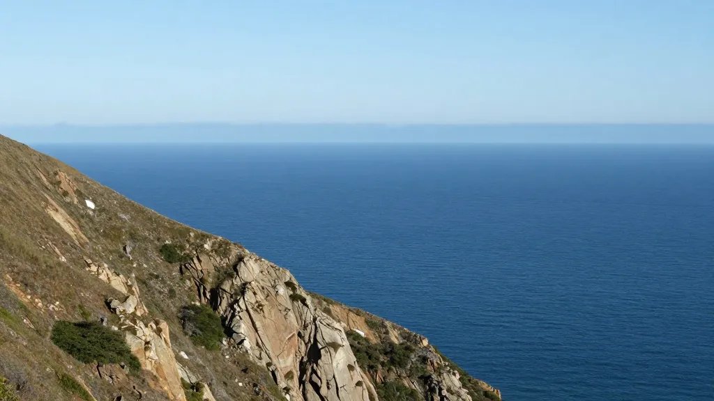 Distant view of coastal cliff from Mount Tamalpais, deep blue water and horizon line