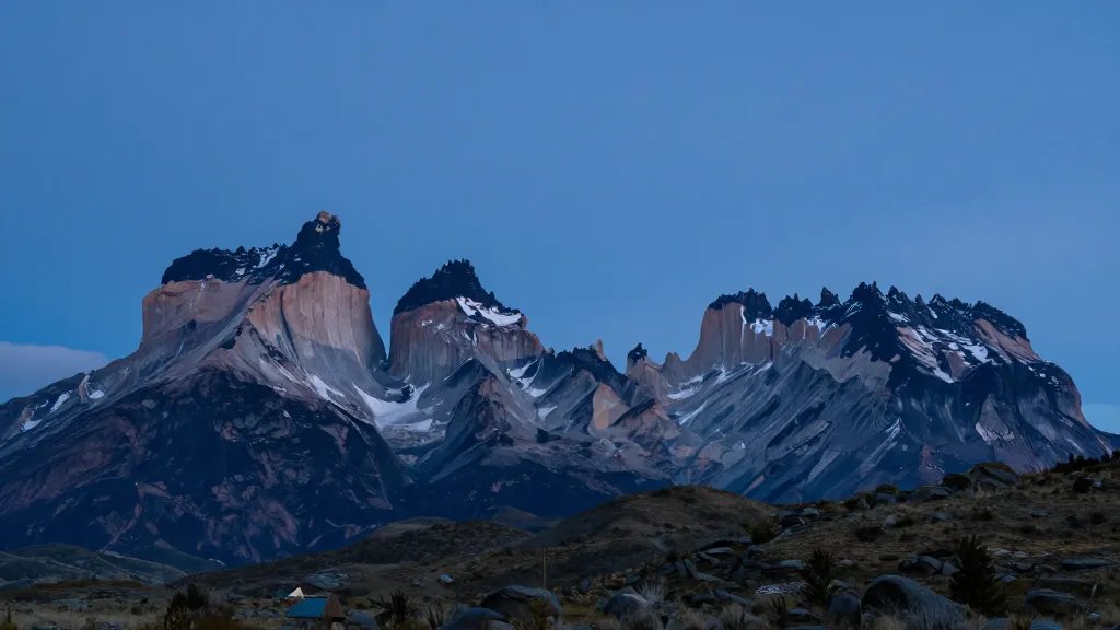 Wide panorama of dramatic Torres del Paine skyline at blue hour