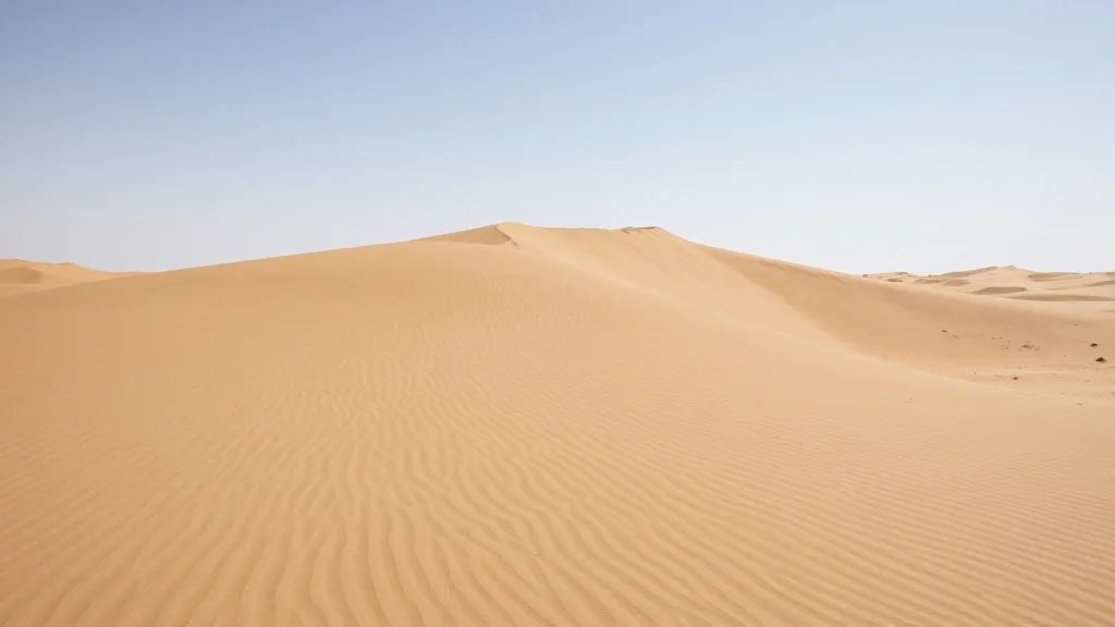 Expansive desert horizon with a solitary dune crest and wind-sculpted ripples under clear sky