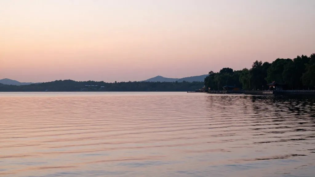 Golden hour lake shoreline loop at dusk, soft pastel reflections