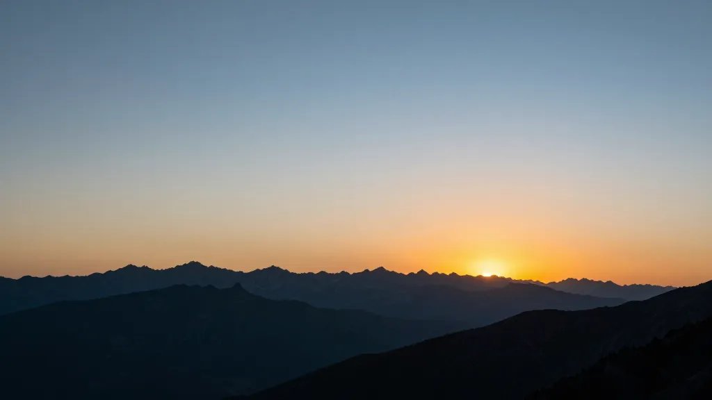 Distant alpine rim sunset over jagged horizon