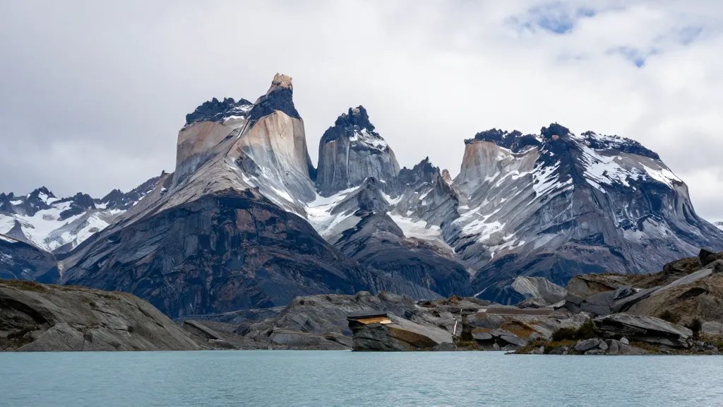 Distant view of Torres del Paine granite towers rising above a glacial lake