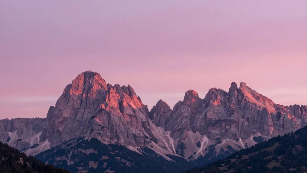 Distant panorama of the Dolomites pink-morning light on jagged peaks