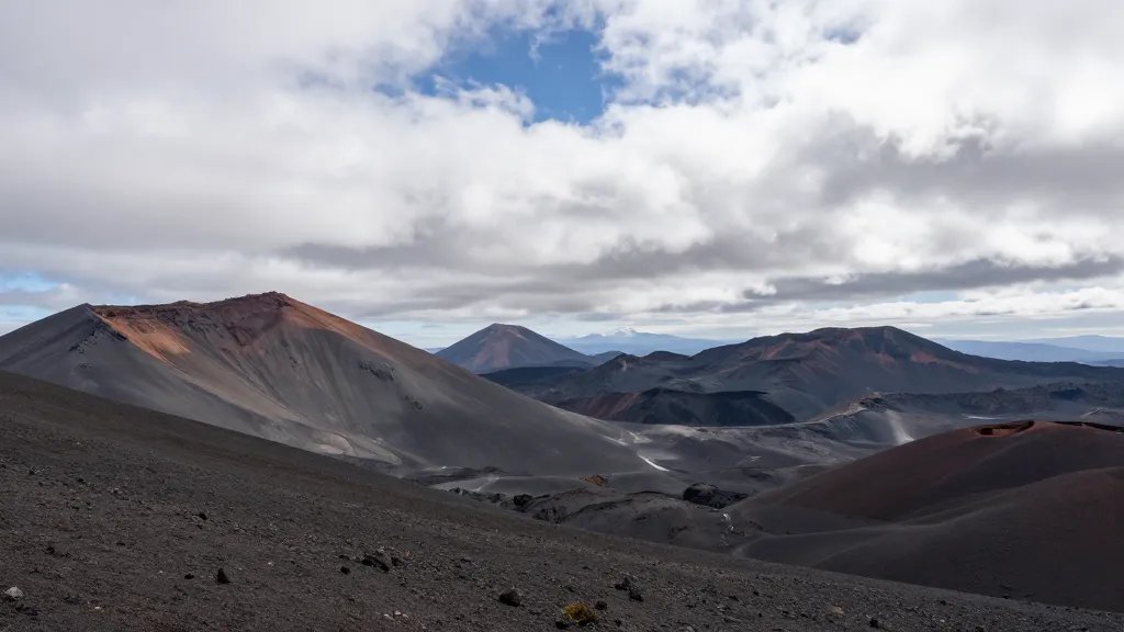 Expansive Pacific Crest section with volcanic terrain under high clouds