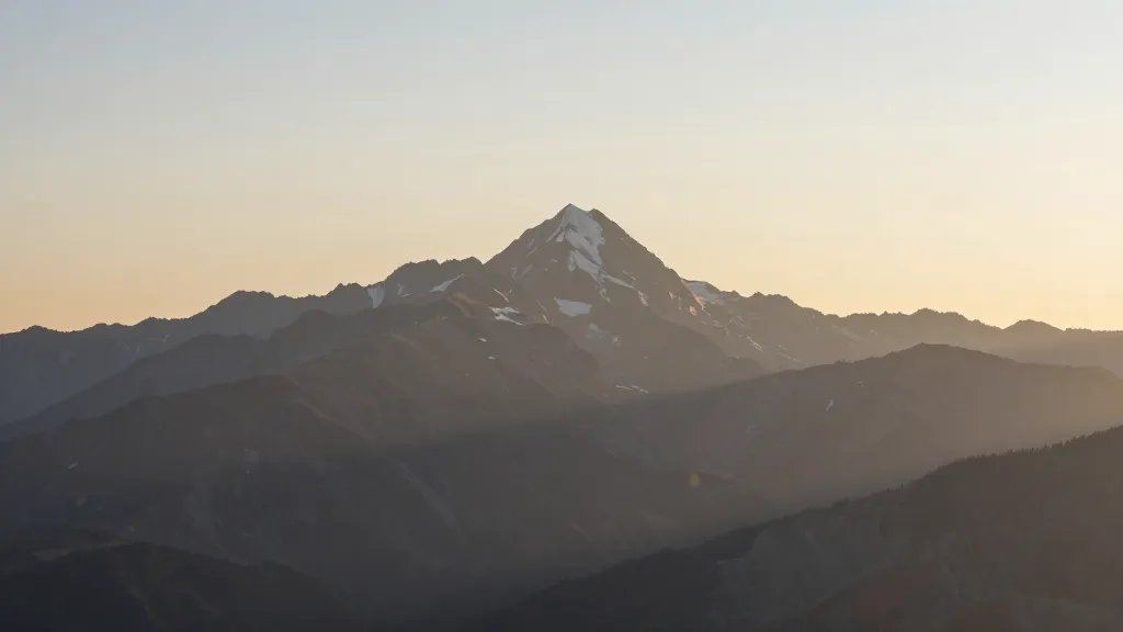Distant view of Alpine Ridge Peak under sunrise light