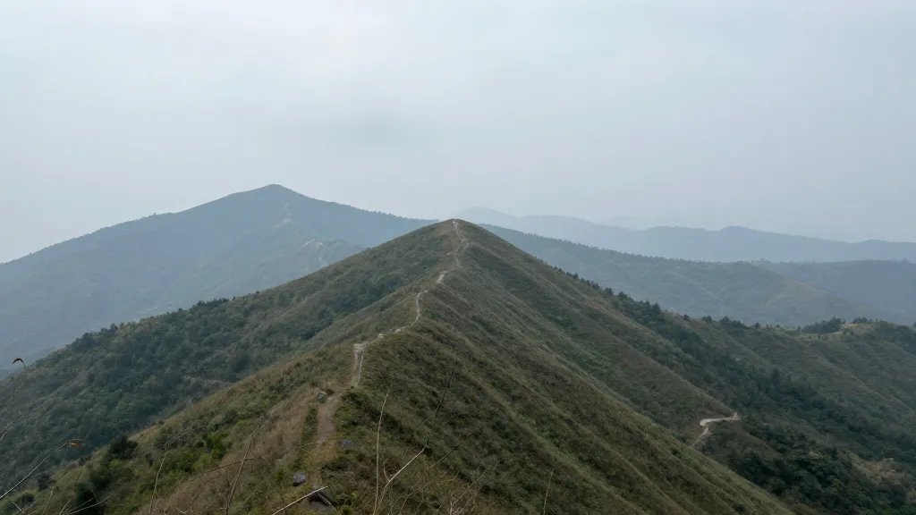 Expansive overlook of a lesser-known ridge with misty distant hills