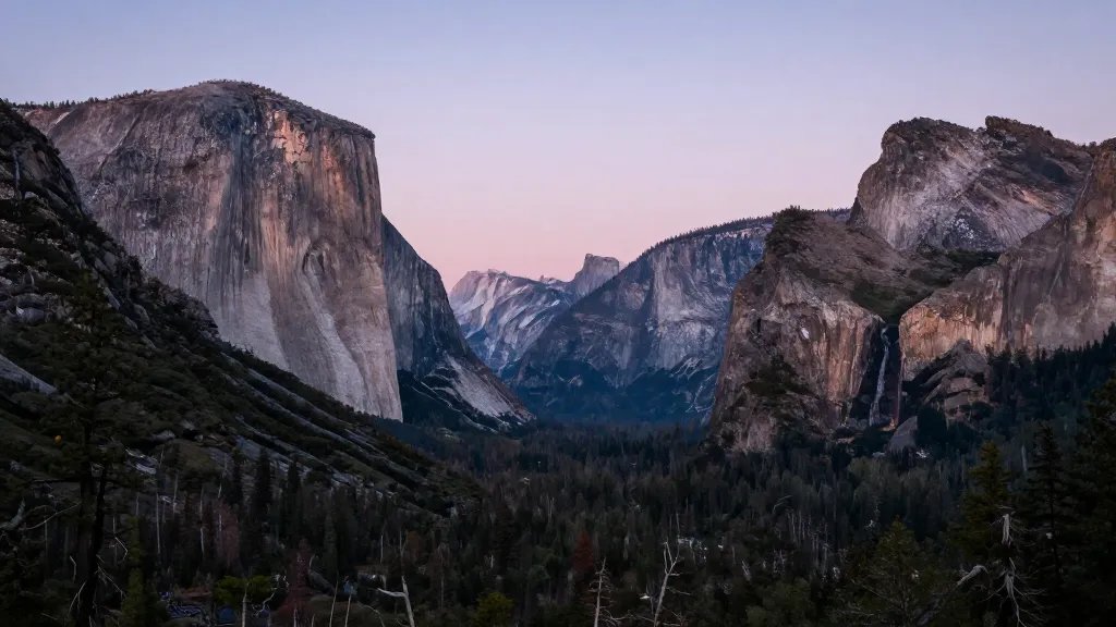 Distant granite peaks and pines in Yosemite Valley twilight