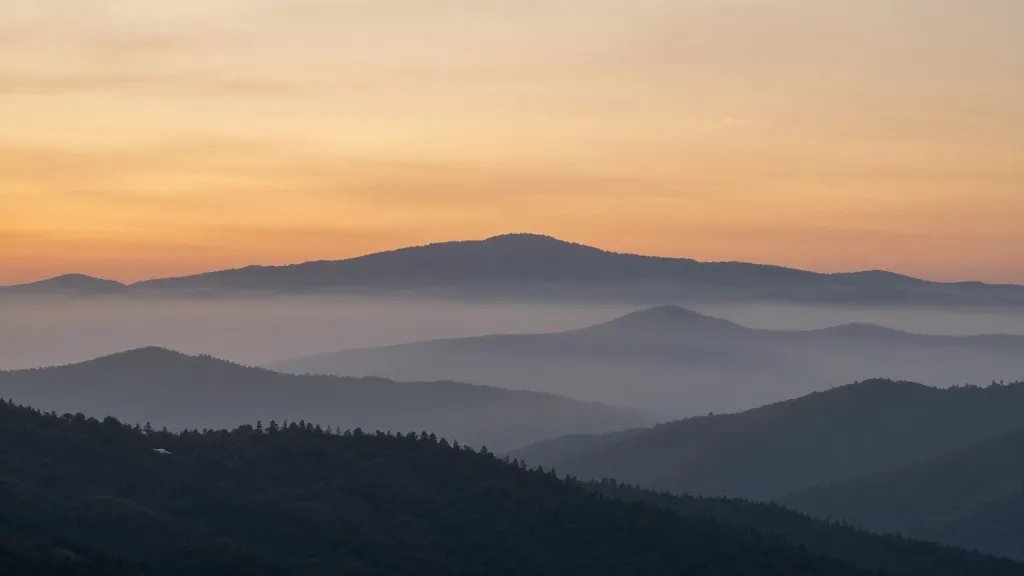 Distant sunrise over Blue Ridge misty valleys