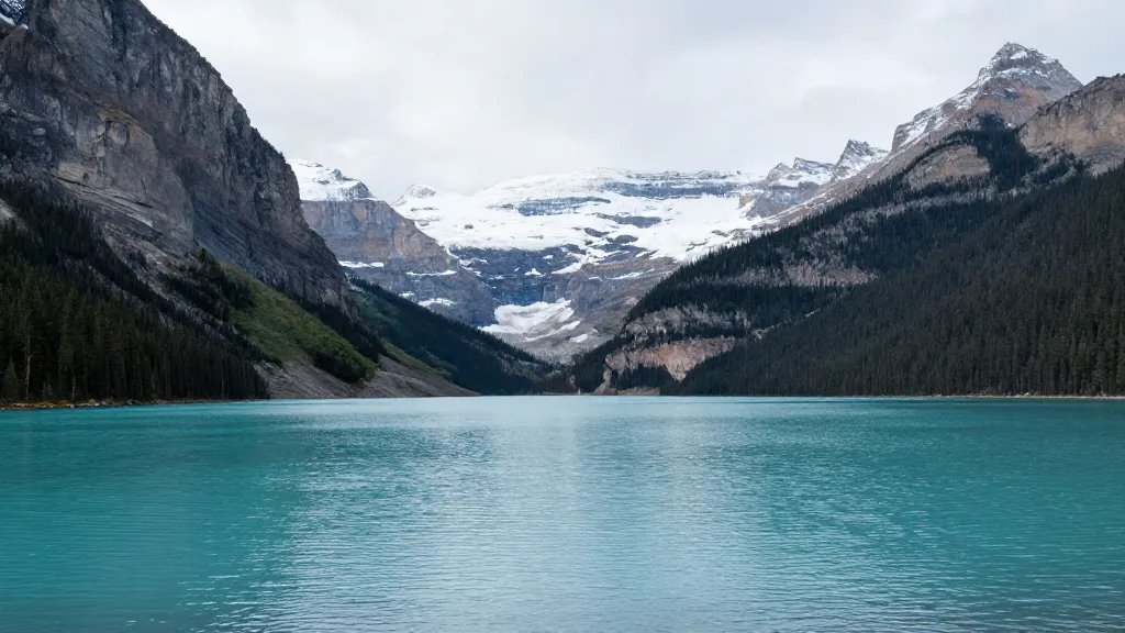 Distant shot of Lake Louise emerald waters with towering Rockies background