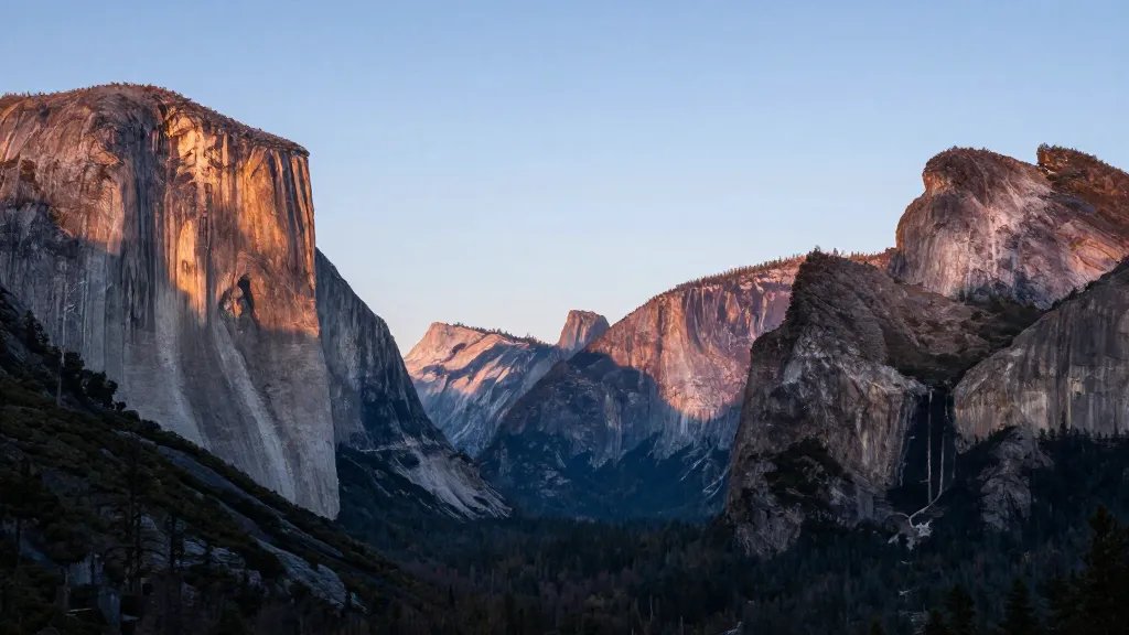Distant view of Yosemite Grand Convergence granite cliffs at dawn