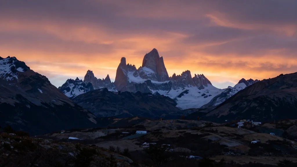Wide view of Patagonian valley with Fitz Roy silhouette at sunset